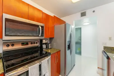 a kitchen with a stove and a refrigerator at Bright and Cozy 2BR at Brickell, Free Parking in Miami