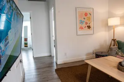 a living room with a tv and a table at Casa MIA central location, free parking, fully equipped in Miami