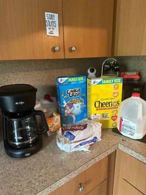 a counter top with a coffee maker and food on it at Miami House in Miami