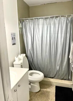 a bathroom with a toilet and a sink and a shower at Miami House in Miami