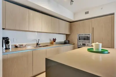 a kitchen with wooden cabinets and a counter top at Amazing apartments at Lyfe Resort & Residences in Hollywood
