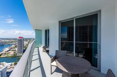 a balcony with a table and chairs on a building at Amazing apartments at Lyfe Resort & Residences in Hollywood