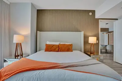 a bedroom with a large bed with orange pillows at Amazing apartments at Lyfe Resort & Residences in Hollywood