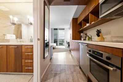 a kitchen with wooden cabinets and a sink at Biscayne Bay View Stay Pool Hot Tub and Amenities in Miami