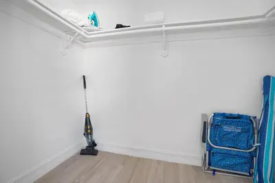 a room with a vacuum in the corner of a room at Blue Door Duplex Renovated Parking and Designed in Cutler Bay