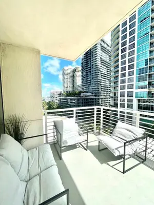 a balcony with white furniture and a view of a city at City Condo in Midtown Wynwood with pool and parking in Miami