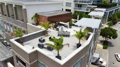 an aerial view of a building with palm trees on the roof at City Condo in Midtown Wynwood with pool and parking in Miami