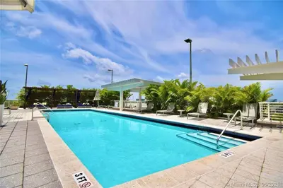 a swimming pool at a resort with blue water at City Condo in Midtown Wynwood with pool and parking in Miami