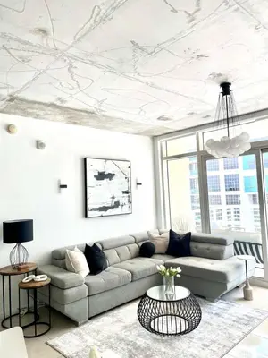 a living room with a couch and a table at City Condo in Midtown Wynwood with pool and parking in Miami