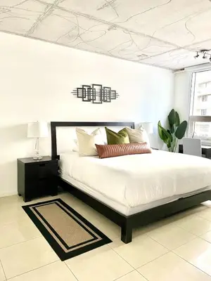 a bedroom with a large white bed in a room at City Condo in Midtown Wynwood with pool and parking in Miami