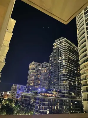 a view of a tall building at night at City Condo in Midtown Wynwood with pool and parking in Miami