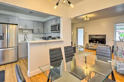 a kitchen and dining room with a glass table at Central Miami Home about 10 Mi to Local Beaches! in Miami