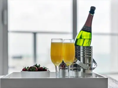 two glasses of champagne and a bottle of wine at Beachside Contemporary Residence in Lyfe in Hollywood