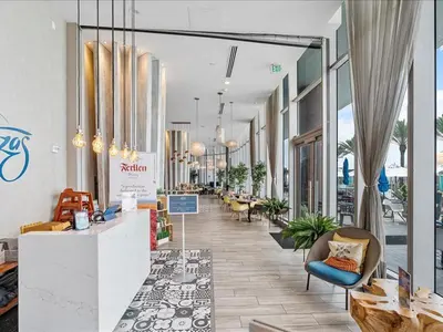 a lobby with chairs and tables in a building at Beachside Contemporary Residence in Lyfe in Hollywood