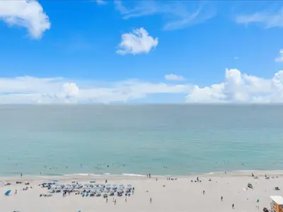 a group of people on a beach with the ocean at Beachside Contemporary Residence in Lyfe in Hollywood