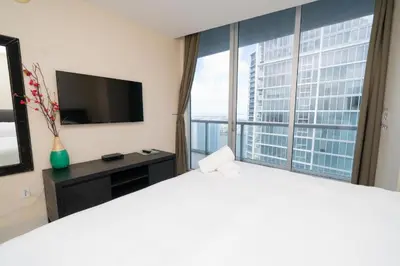 a hotel room with a large bed and a large window at W Hotel Miami Stunning Private Condo With Access to All Hotel Amenities in Miami