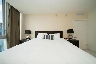 a bedroom with a large white bed and two lamps at W Hotel Miami Stunning Private Condo With Access to All Hotel Amenities in Miami