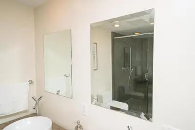 a white bathroom with a sink and a mirror at W Hotel Miami Stunning Private Condo With Access to All Hotel Amenities in Miami