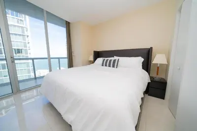 a bedroom with a white bed and a large window at W Hotel Miami Stunning Private Condo With Access to All Hotel Amenities in Miami