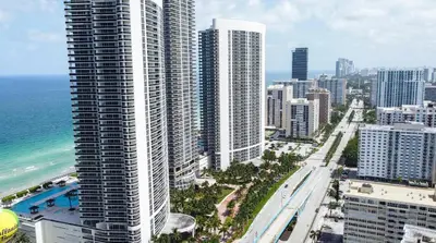 an aerial view of a city with tall buildings and the ocean at YP PROPERTY MANAGEMENT in Hollywood