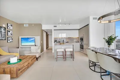 a kitchen and living room with a couch and a table at Insane Ocean View Balcony- Beachfront Resort - Pools in Hollywood