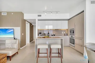 a kitchen with a table and two chairs and a counter at Insane Ocean View Balcony- Beachfront Resort - Pools in Hollywood