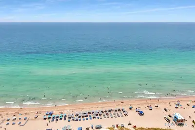 an aerial view of a beach with people in the water at Insane Ocean View Balcony- Beachfront Resort - Pools in Hollywood