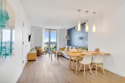a living room with a table and a couch at Spectacular Balcony plus Near Beach, Gym, Pool in Hallandale Beach