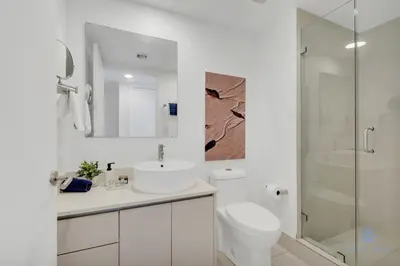 a white bathroom with a sink and a shower at Infinite Views with Amazing Pool plus Gym, Near Beach in Hallandale Beach