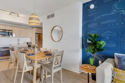 a dining room and kitchen with a table and chairs at Infinite Views, Amazing Pool, Gym, Near Beach in Hallandale Beach
