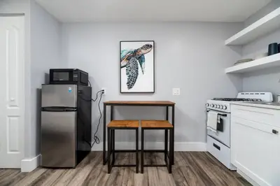 a kitchen with a table and a refrigerator at Shell on the Beach 107 - RENOVATED in Hollywood