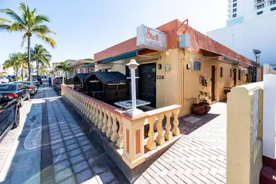 a building with a restaurant on a street at Shell on the Beach 107 - RENOVATED in Hollywood