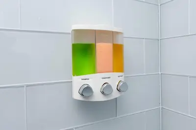 a soap dispenser on a white tiled bathroom wall at Shell on the Beach 105 - RENOVATED in Hollywood