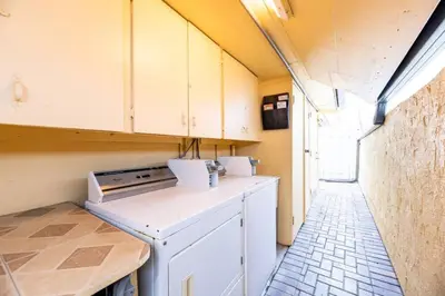 a small kitchen with a stove and a dishwasher at Shell on the Beach 102 - RENOVATED in Hollywood