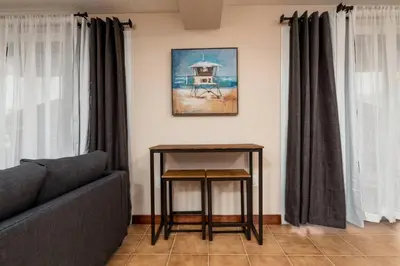 a living room with a couch and a table at Shell on the Beach 101 in Hollywood