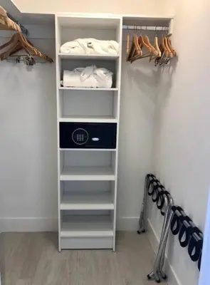 a walk in closet with a shelf with towels and shoes at Luxury apartment- Hyde House Resort in Hollywood