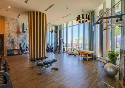 a gym with exercise equipment and large windows at Ocean View Balcony, Beachfront Resort, Amazing Pool in Hollywood