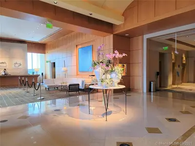 a lobby with a table with flowers on it at Four Seasons Studio - Privately Owned Unit in Miami