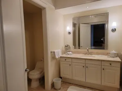 a bathroom with a sink and a toilet and a mirror at Four Seasons Studio - Privately Owned Unit in Miami