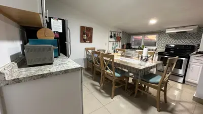 a kitchen and dining room with a table and chairs at Private Rooms in Miami