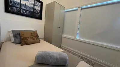 a room with a bed with a pillow and a window at Private Rooms in Miami