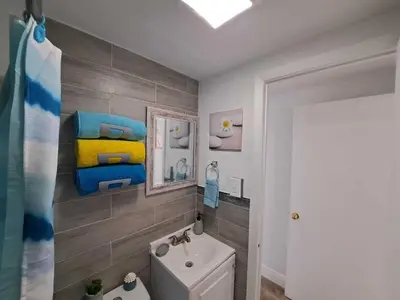 a bathroom with a toilet and a sink and a mirror at Relax 521- at the side in Miami