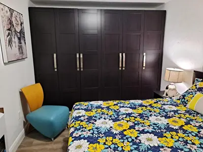 a bedroom with a bed and a blue chair at Relax 521 in Miami
