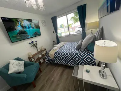 a bedroom with a bed and a table and a chair at Relax 521 in Miami