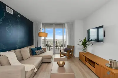 a living room with a couch and a chalkboard wall at Infinite View and Balcony with Pool, Near Beach in Hallandale Beach