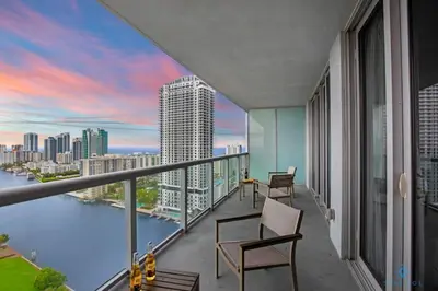 a balcony with chairs and a view of the city at Infinite View and Balcony with Pool, Gym, Near Beach in Hallandale Beach