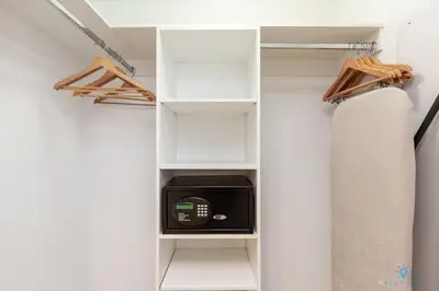a walk in closet with white shelves and a microwave at Infinite View and Balcony with Pool, Gym, Near Beach in Hallandale Beach