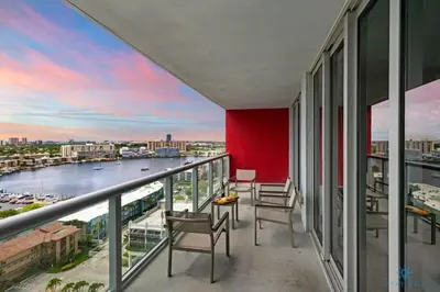 a balcony with chairs and a view of a river at Infinite View with Balcony, Gym, Pool in Hallandale Beach