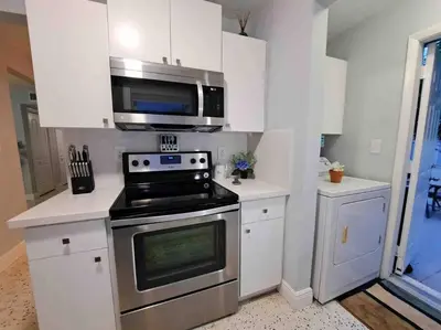 a kitchen with a stove and a microwave at Relax 523 in Miami