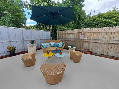 a patio with a table and chairs and an umbrella at Relax 523 in Miami